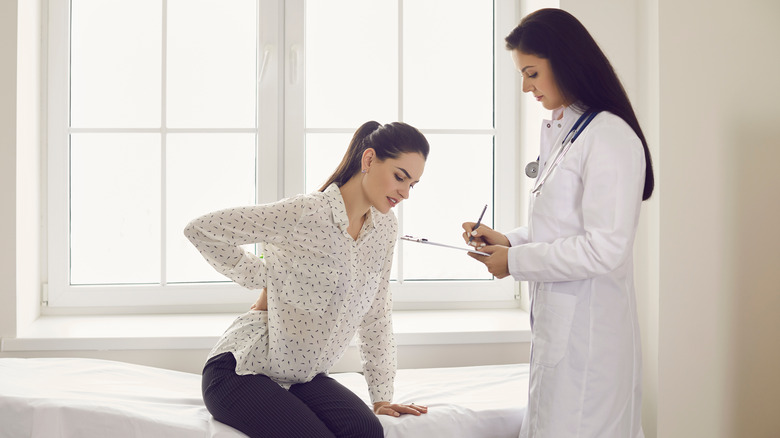 Woman with back pain seeing doctor