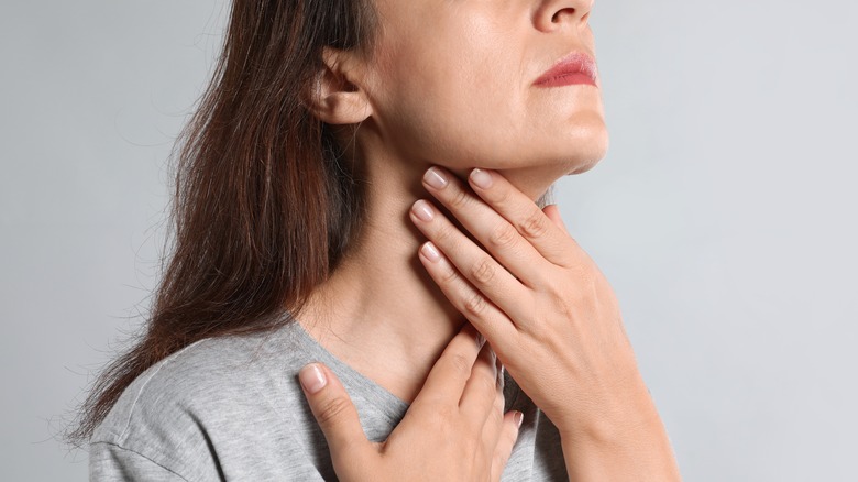 woman examining neck