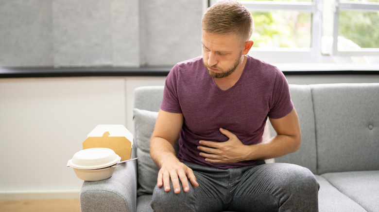 Man with discomfort after eating from heartburn