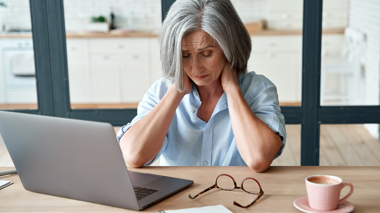 Woman feeling pain at computer