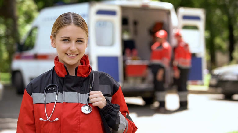 EMT in front of ambulance