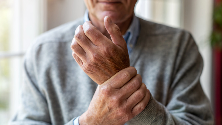 man holding sore wrist