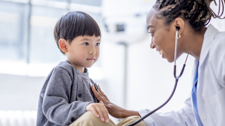 Doctor examining child