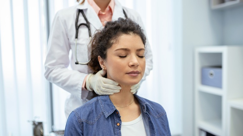 doctor checking patient's throat