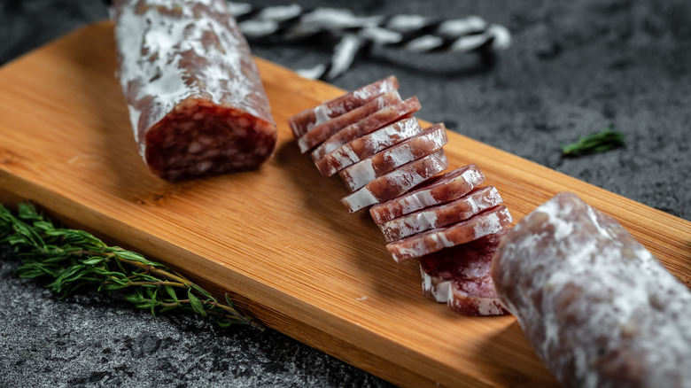 Slices of hard salami on cutting board