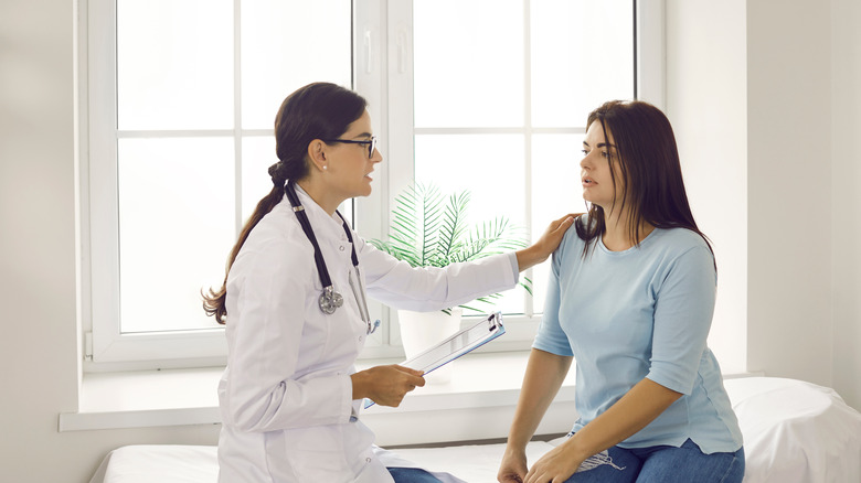 Concerned doctor with patient