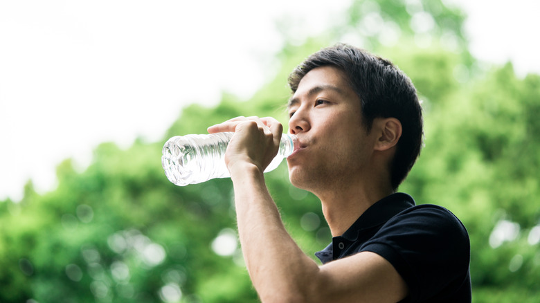 young man drinking water