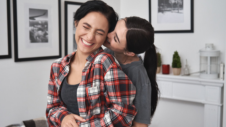 a couple standing and cuddling