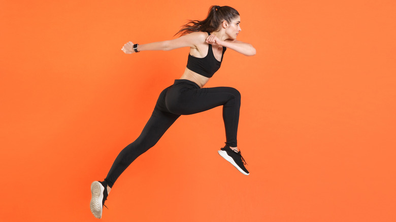 woman jumping demonstrating strength