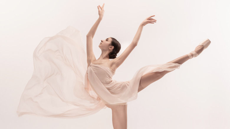 ballerina dancing gracefully with white background