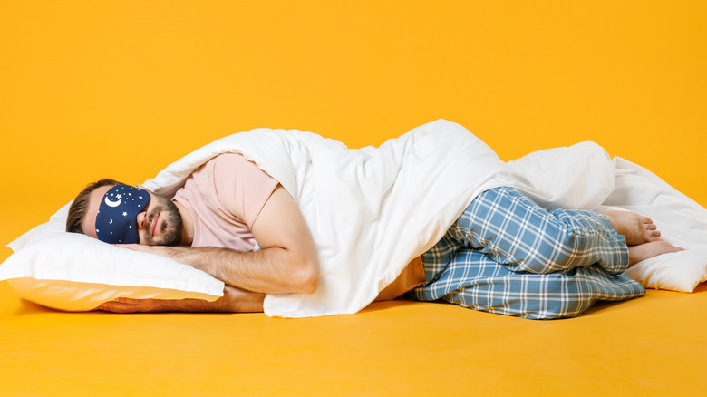 man sleeping in yellow room