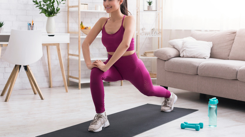 woman lunging on yoga mat