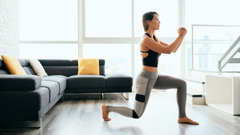 woman doing lunge in home