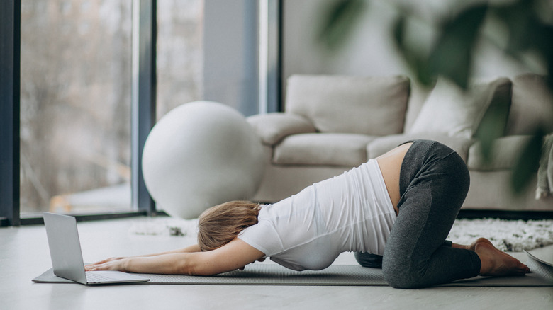 Pregnant woman doing yoga at home