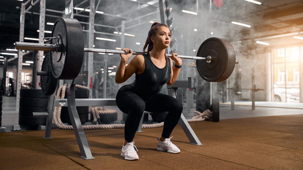 woman squatting with weight