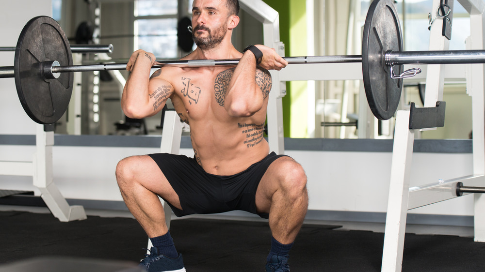 man doing weighted squat