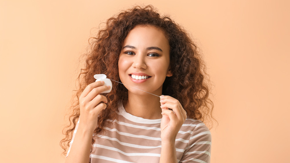 Woman holding floss in hands 