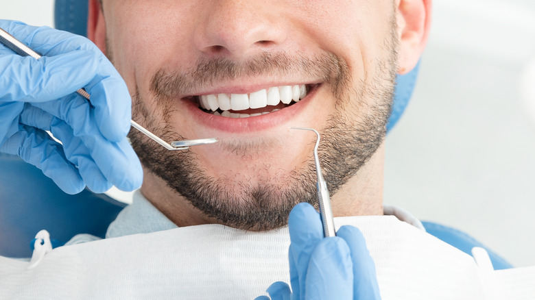 man at dentist smiling