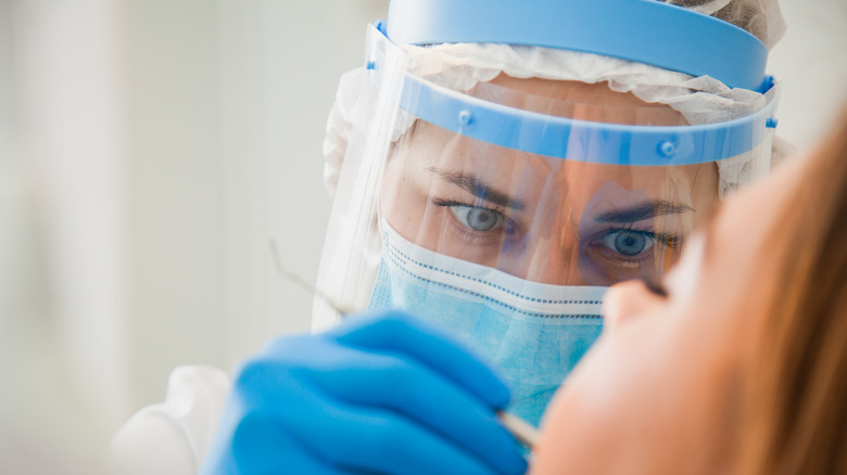 female dentist with mask on