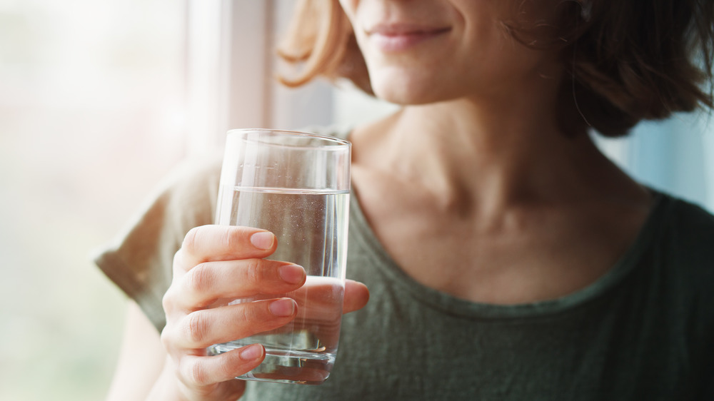 woman drinking a glass of water