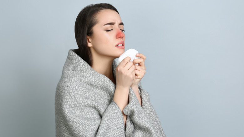 woman with red congested nose sick