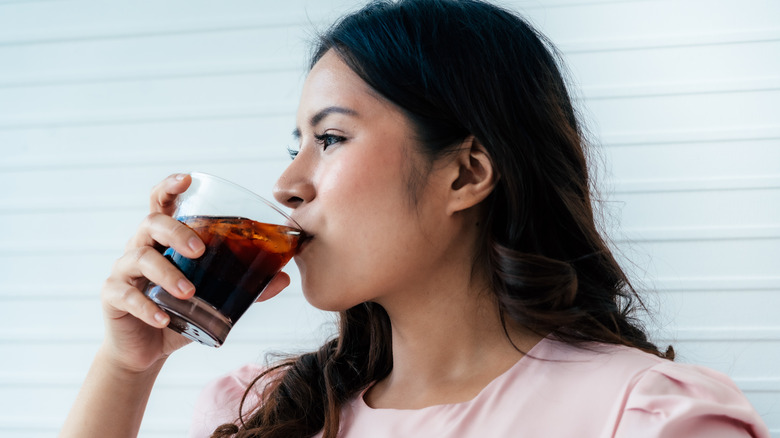 woman drinking a soda