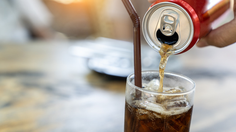 can of Coke pouring into glass