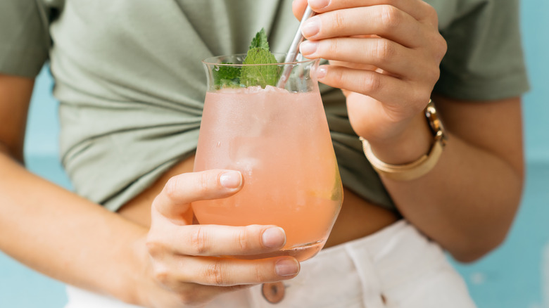 Woman holding grapefruit juice