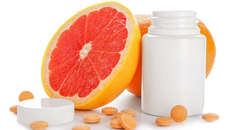 Grapefruit and pills with bottle