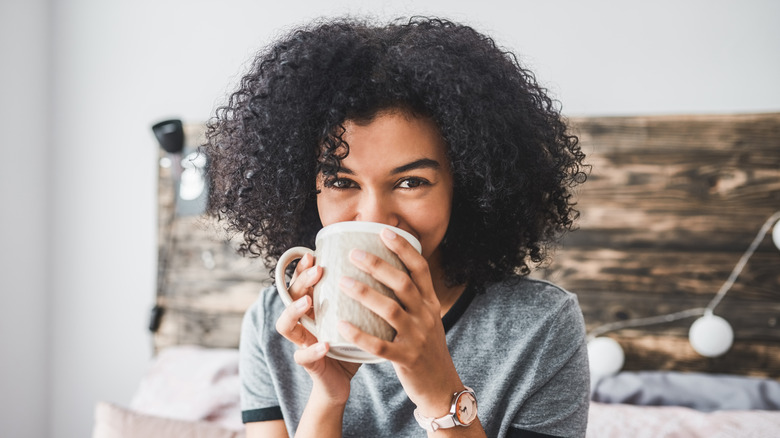 woman drinking a cup of coffee in the afternoon