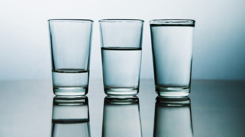 Three water glasses with varying amounts of water