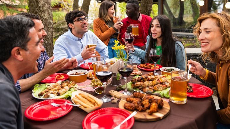 friends eating meat for lunch outdoors