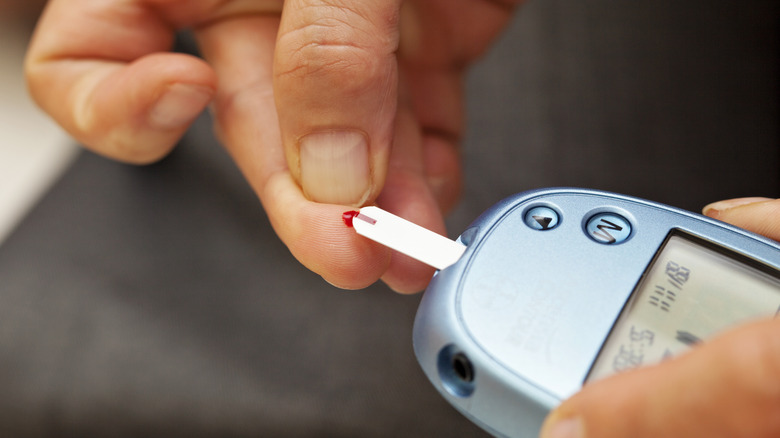 Man checking blood sugar levels