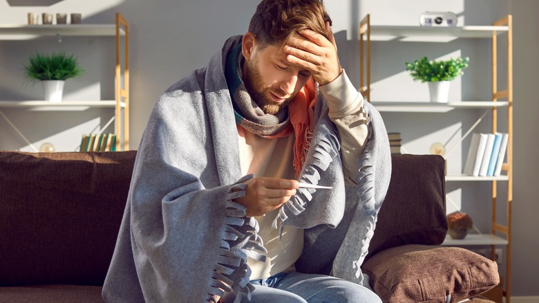 Man feeling sick at home from vitamin deficiency