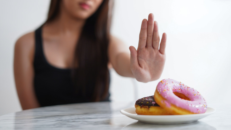 woman saying no to sweets