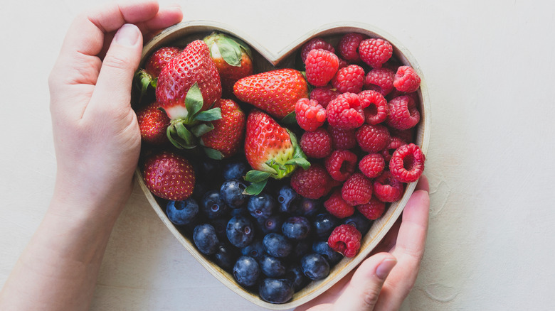 berries in a heart-shaped container