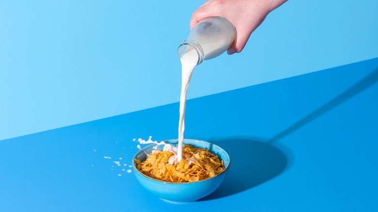 pouring milk in cereal bowl