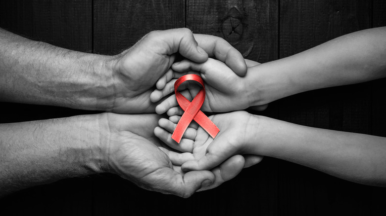 hands holding AIDS ribbon