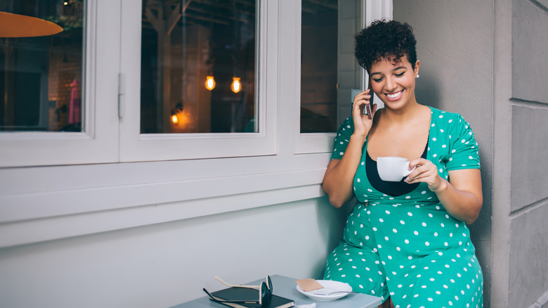 woman looking at tea cup