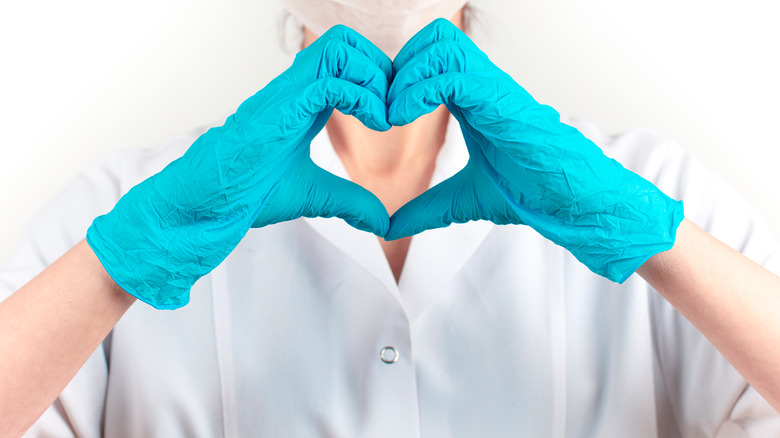 gloved hands making heart shape