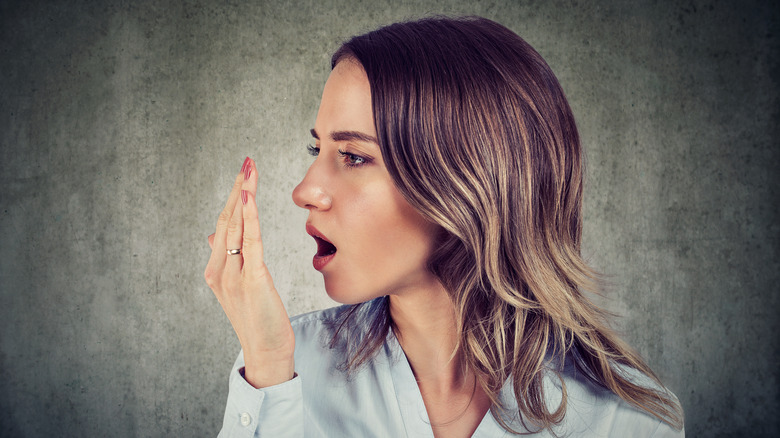 woman testing for bad breath