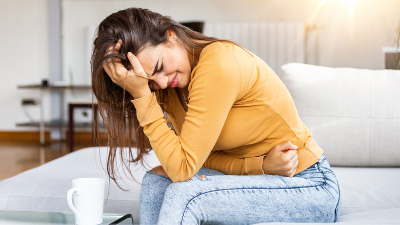 woman holding stomach