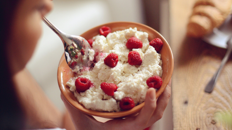 young woman with cottage cheese and fruit