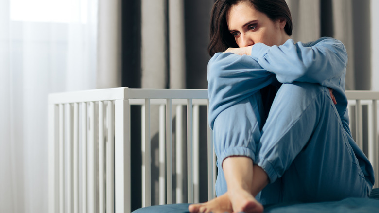 sad woman seated hands crossed 