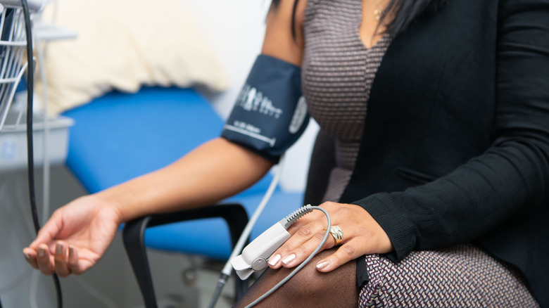 woman getting blood pressure monitored