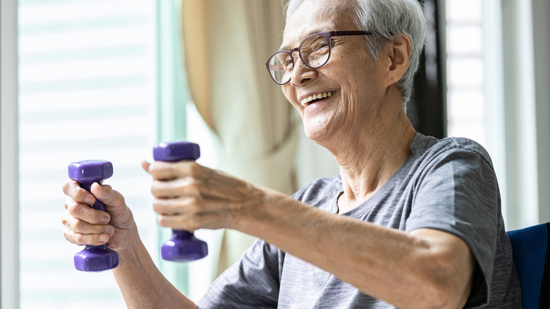 older man with weights