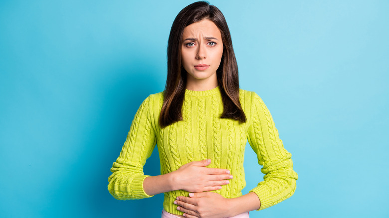 woman holding stomach