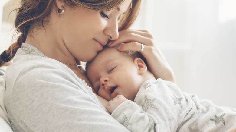 mother holding her sleeping baby