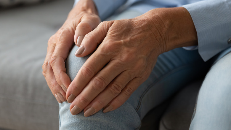 Woman holding knee because of joint pain