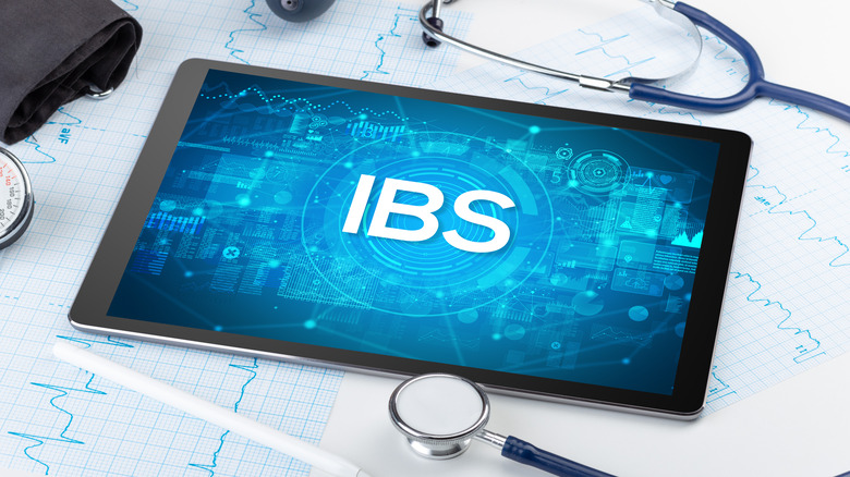 A tablet displaying the letters "IBS" 